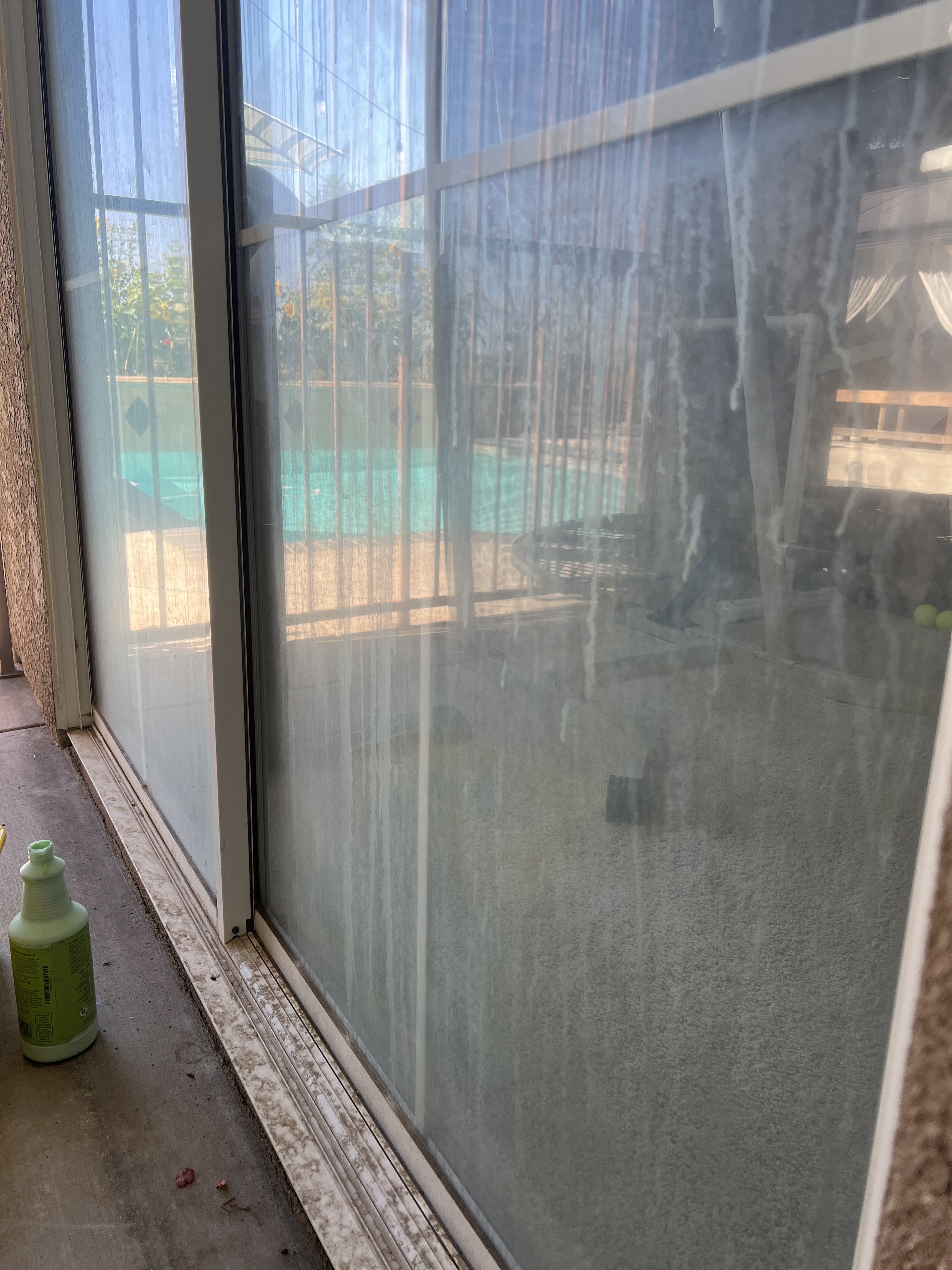 Hard water stains on glass door before removal treatment in Fresno, CA