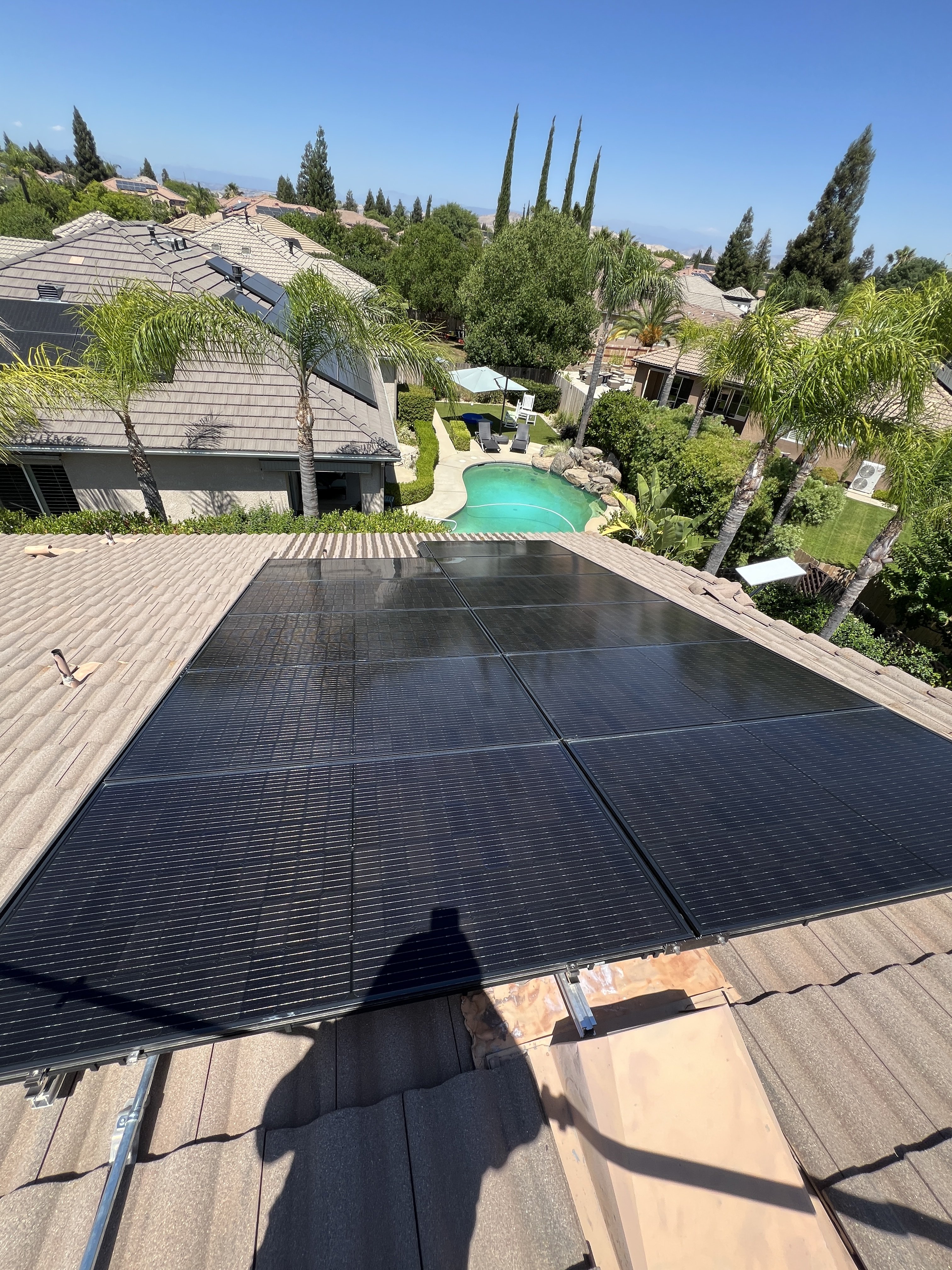 Aerial view of solar panel cleaning service on home roof in Fresno, CA