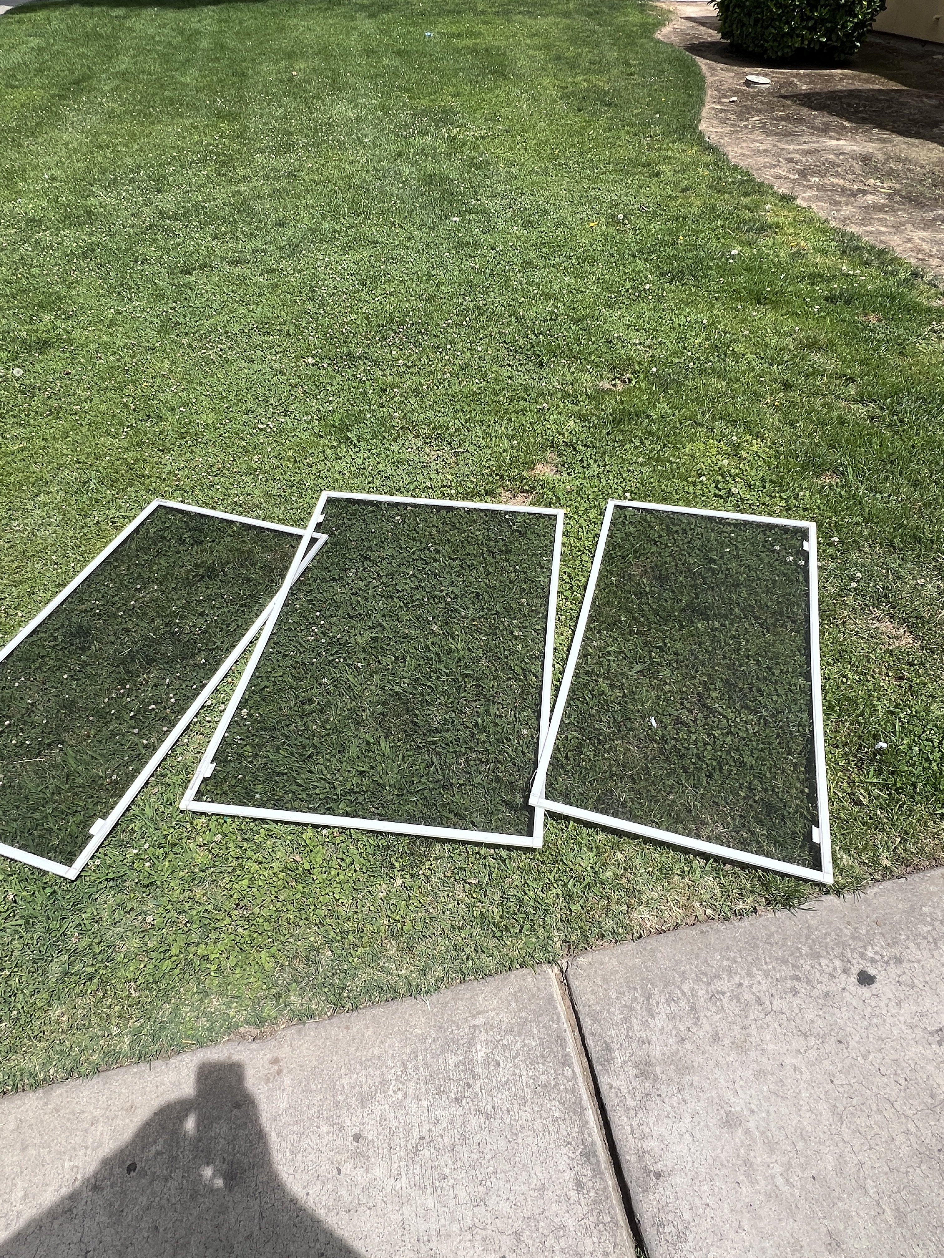 Window screens laid out for repair in Fresno, CA