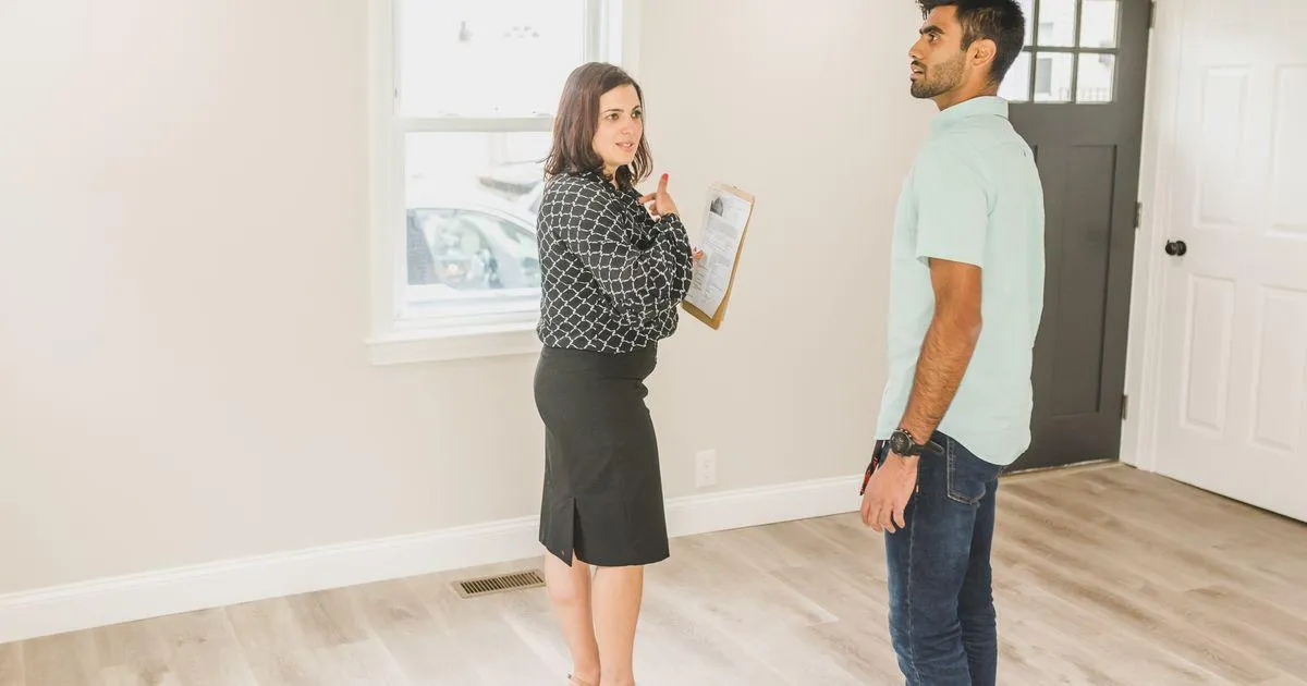 Two sober living operators walking through a residential property with a checklist