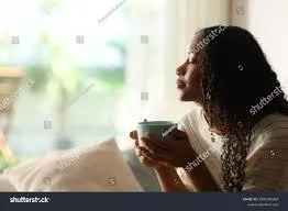 sitting woman leaning on man's shoulder facing lake during golden hour