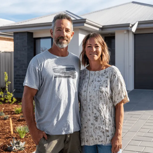 A couple standing n front of a new custom designed home in Perth