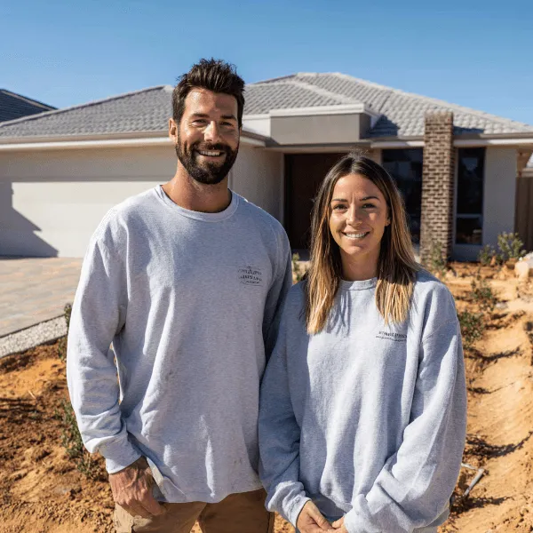 Homeowners standing in front of their newly completed house in Perth, preparing for builder handover and final inspection before accepting practical completion.