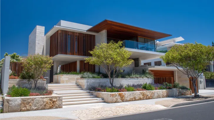 Architectural Design Coordination Perth showing construction plans and cost documents on a table near apartments in Joondanna.