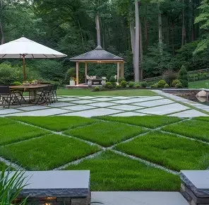 Outdoor seating area with stone paving and a pergola in the background