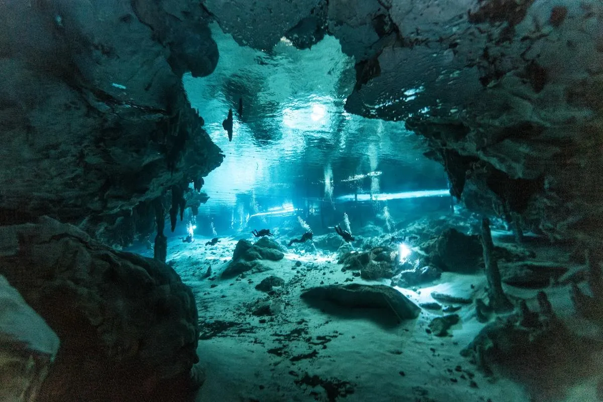 Turquoise blue water inside Dos Ojos cenote cavern system