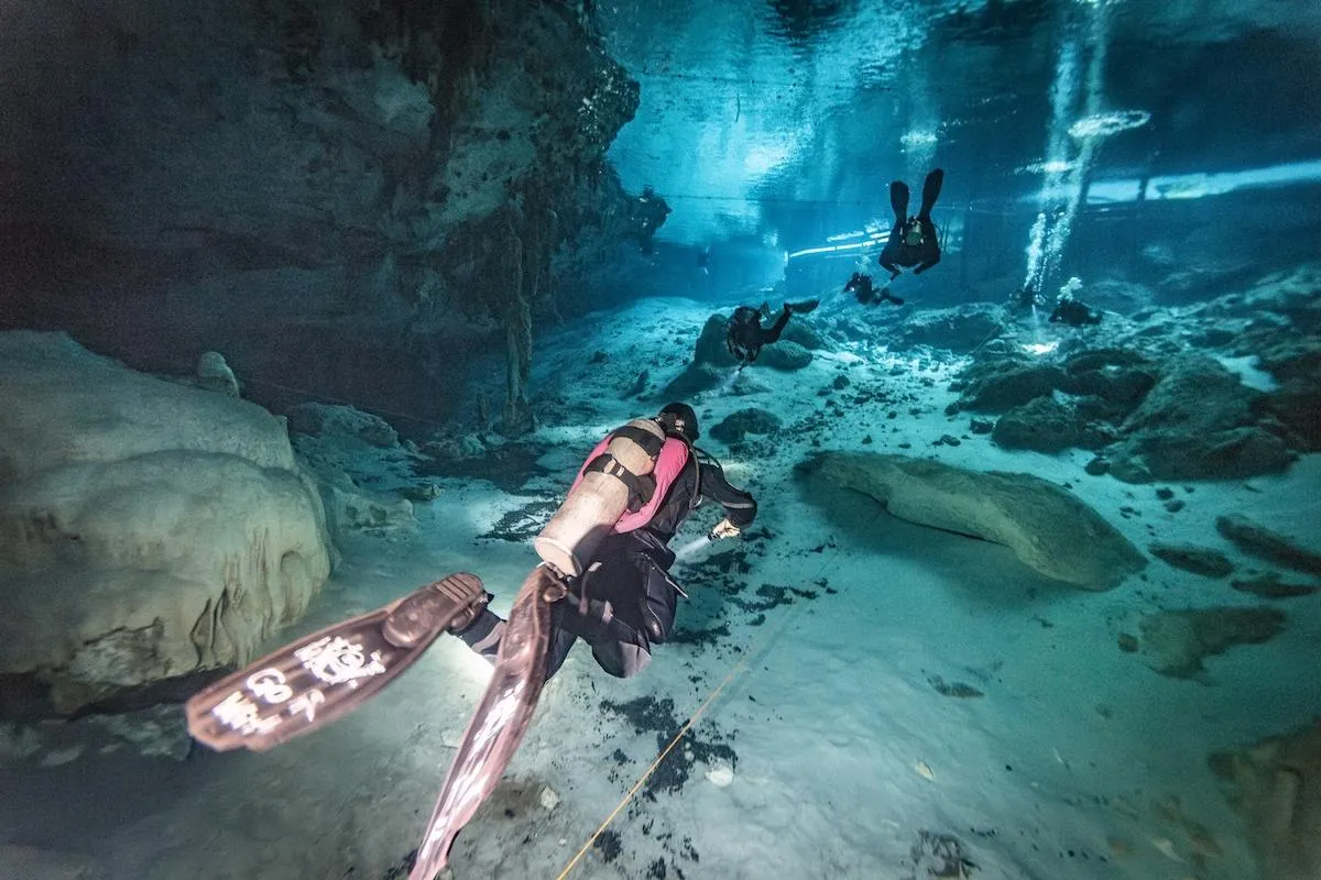 Divers swimming along the Barbie Line at Dos Ojos cenote