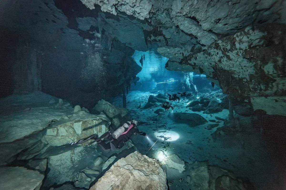 scuba divers in dos ojos cenote