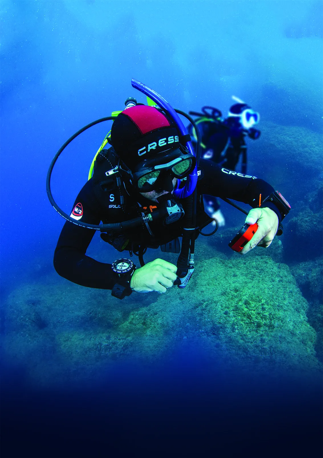 scuba diver checking dive computer