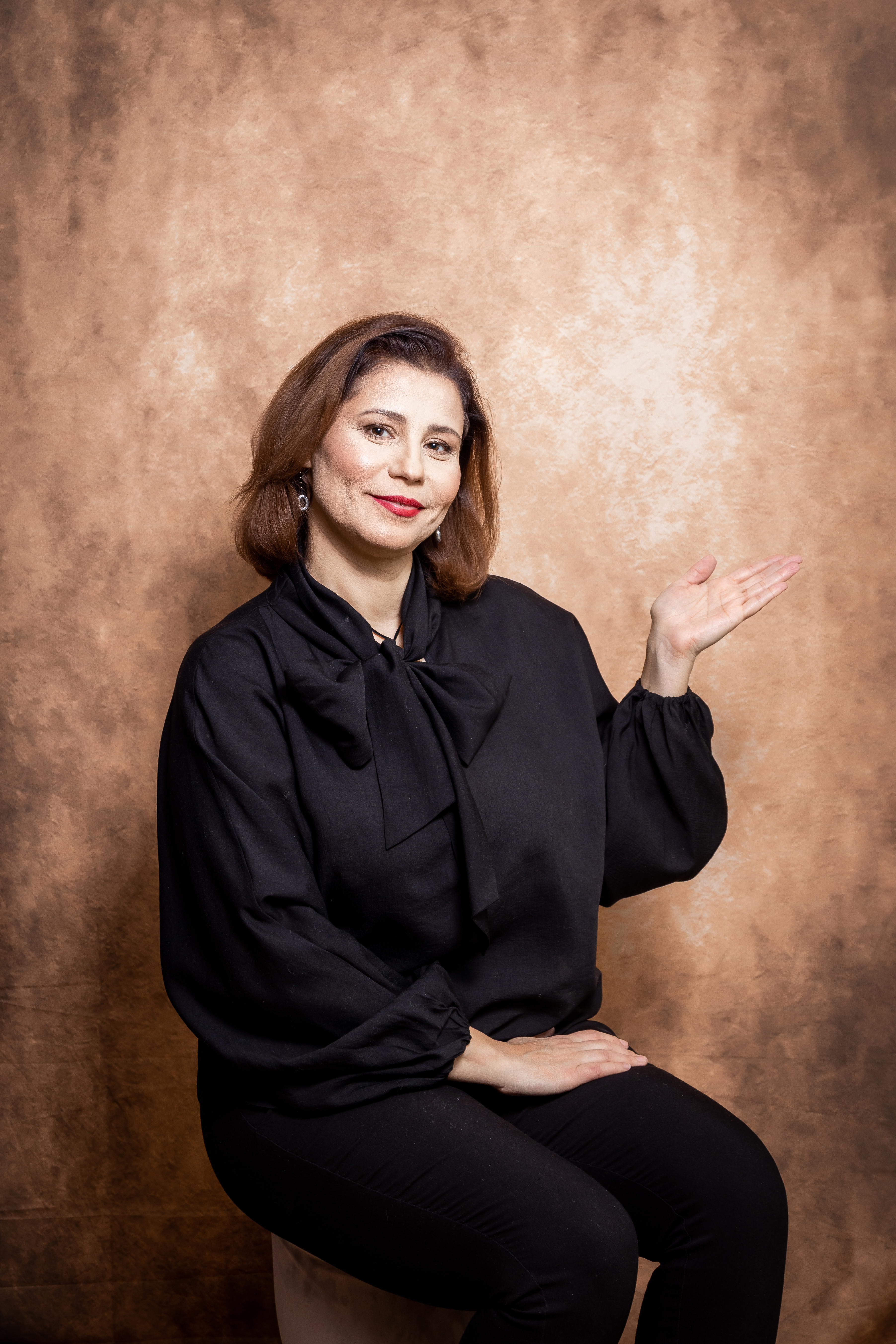 a man sitting on the ground in front of a building