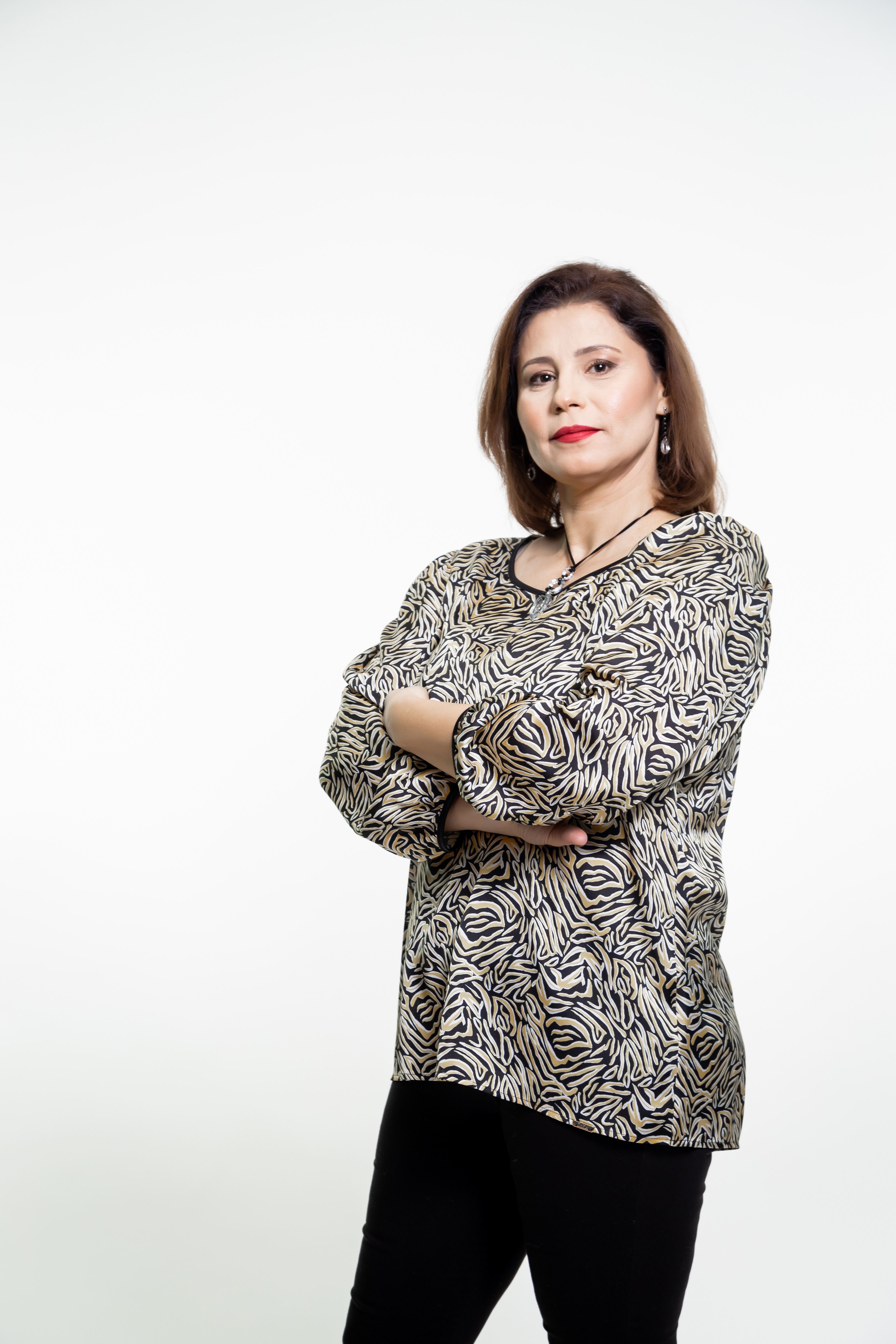 a man sitting on the ground in front of a building