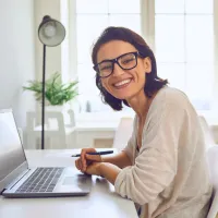 virtual assistant woman at laptop smiling