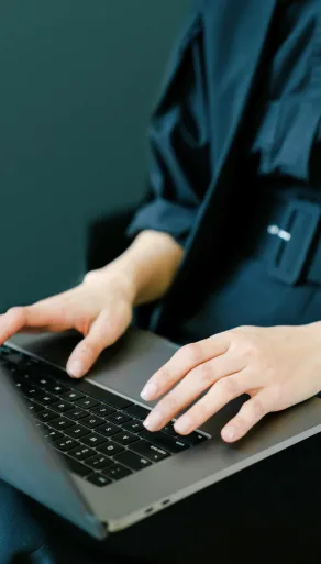 woman in green dress working on laptop