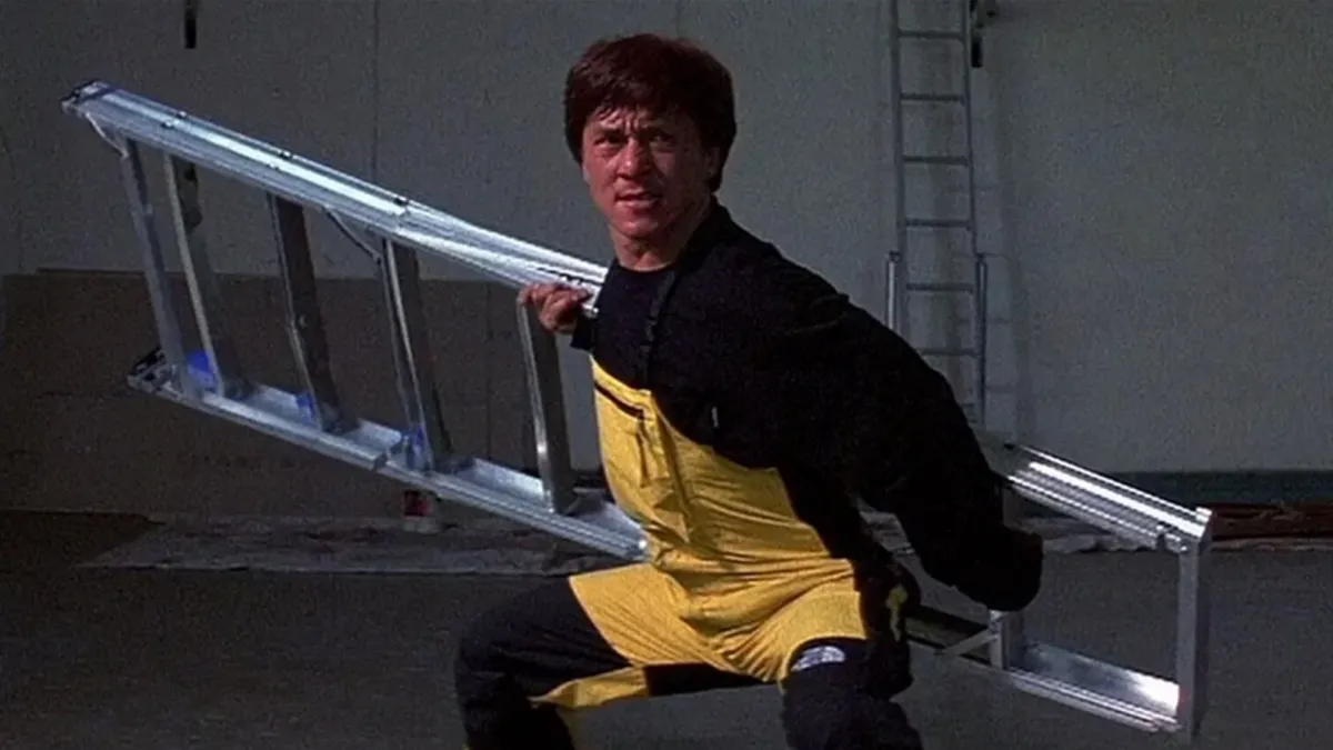 ackie Chan performing ladder fight choreography in First Strike.