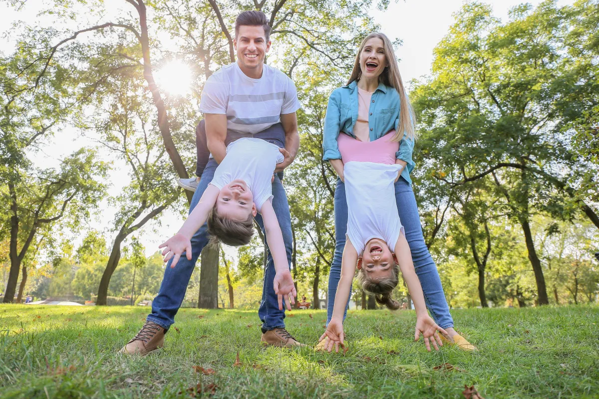 Happy parents playing energetically with kids