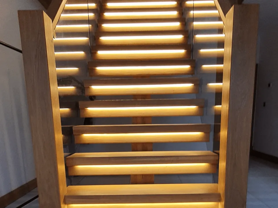  A modern custom staircase with electrical lights under each step that our Carmarthenshire joinery services created
