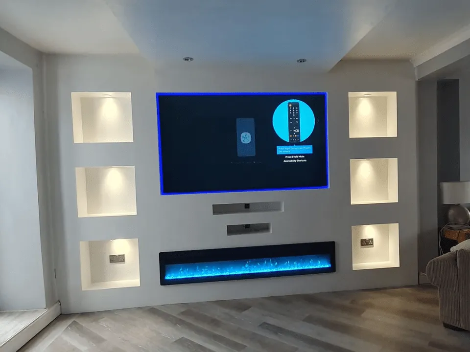 A media wall that we built with built-in sections for a TV and fireplace