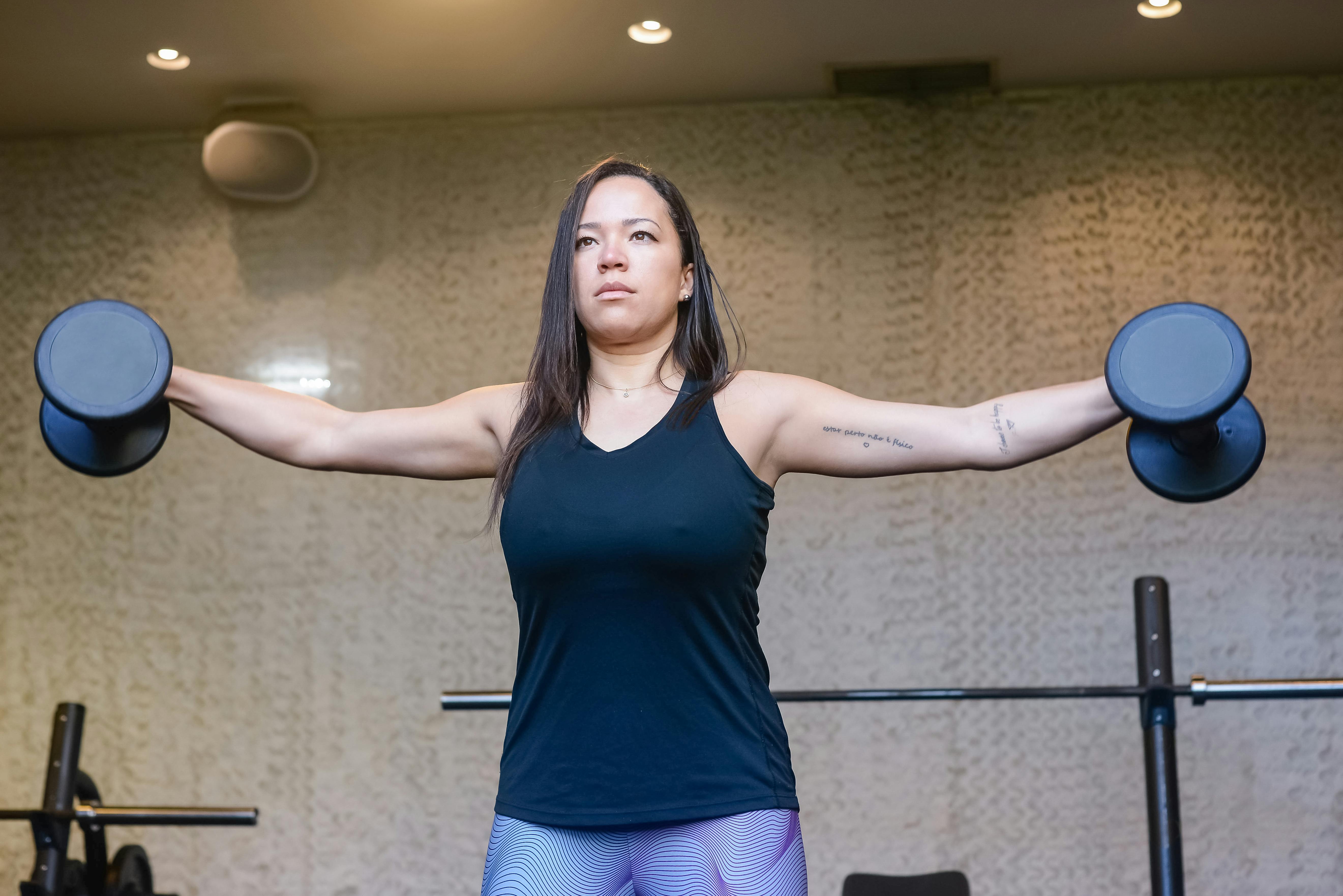 Women doing lateral raise with weights