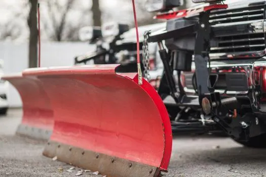 Snowplow attached to the front of a truck for snow removal.