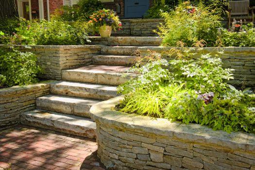 Beautifully designed garden with stone steps and lush greenery, highlighting landscaping design services in Newark, DE