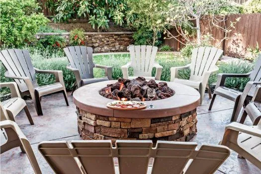 Outdoor fire pit with seating area, featuring custom paver installation.