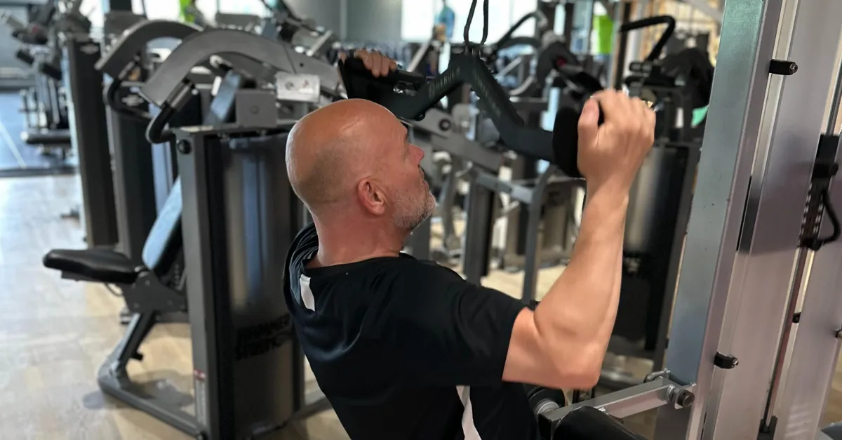 Rob's client a man his 50s doing strength training in Lightwater Leisure Centre.
