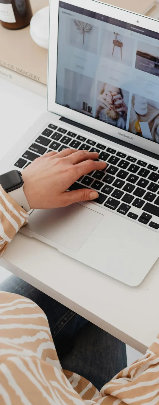Jessica Green and Natasha Roberson standing together in front of white curtains, dressed in casual-chic outfits with confident, welcoming smiles — showcasing the approachable leadership behind the Self Made brand.