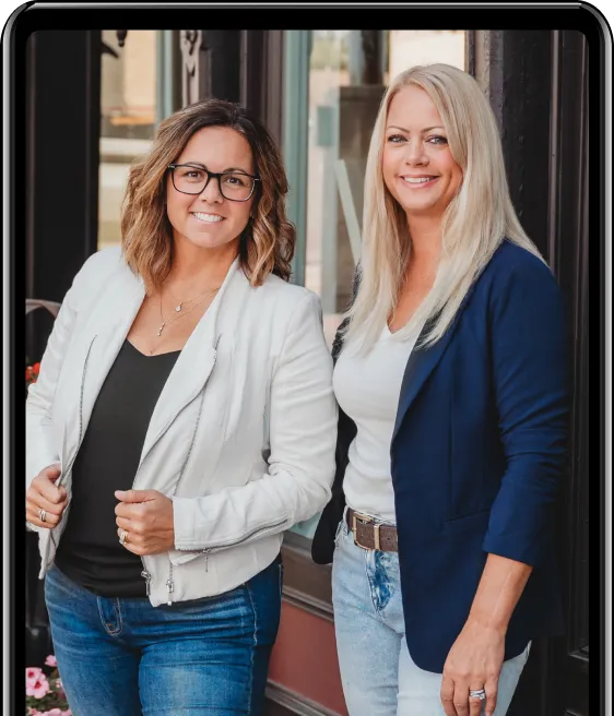 Jessica Green and Natasha Roberson standing outside a storefront, wearing blazers and denim — representing the professional, tech-savvy mentors of the Self Made Hub business automation platform.