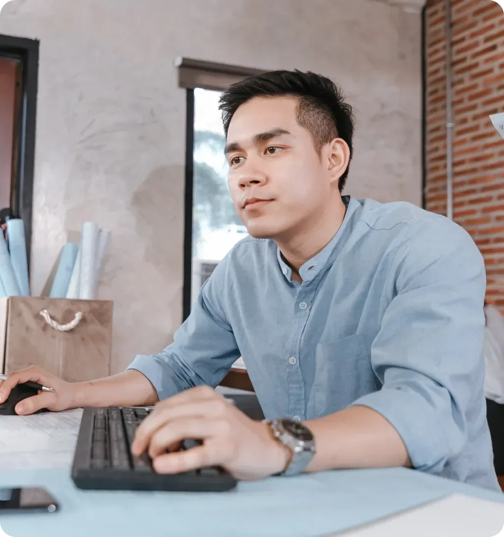 Operations professional working at desk using computer in office environment