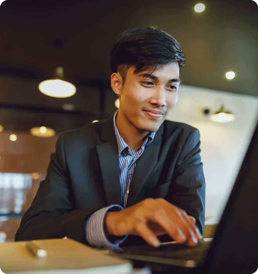 Finance professional working on laptop analyzing data in office setting