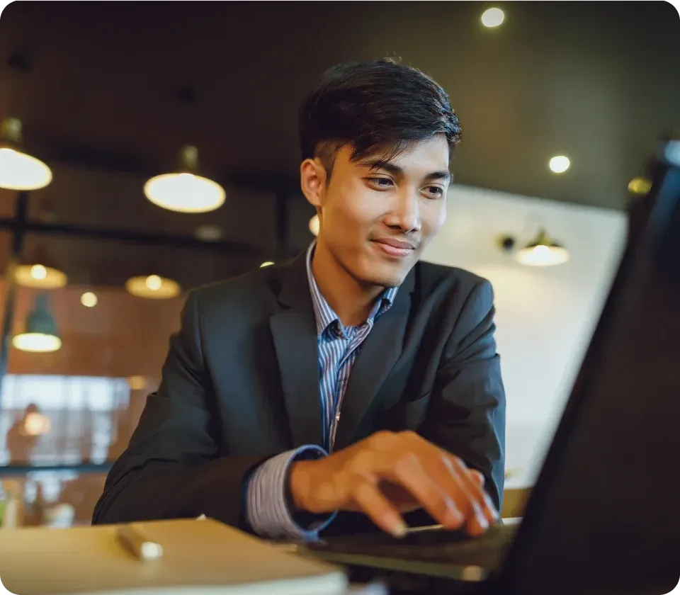 Finance professional working on laptop analyzing data in office setting