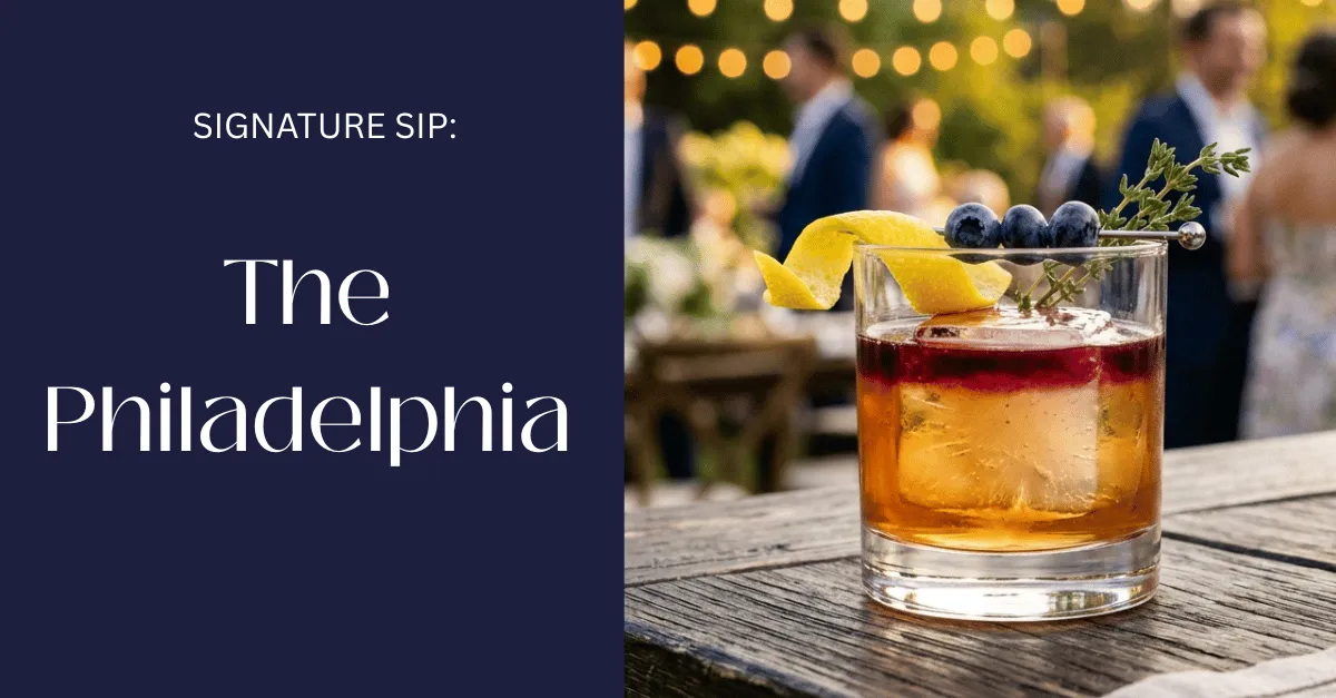 The Philadelphia rye whiskey cocktail with blueberry float and lemon twist in a rocks glass over a large ice cube, elegant summer setting