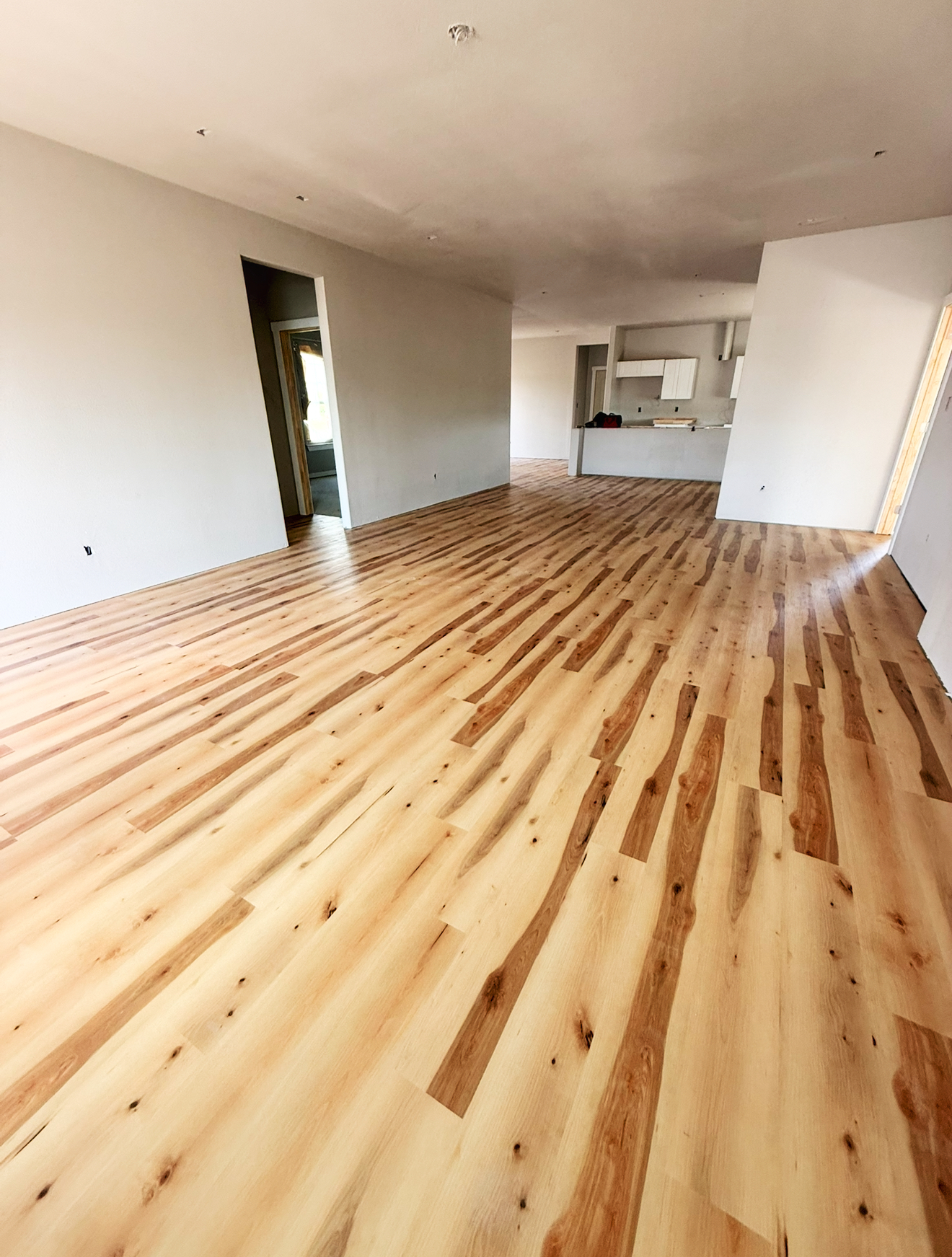 a living room filled with furniture and a painting on the wall