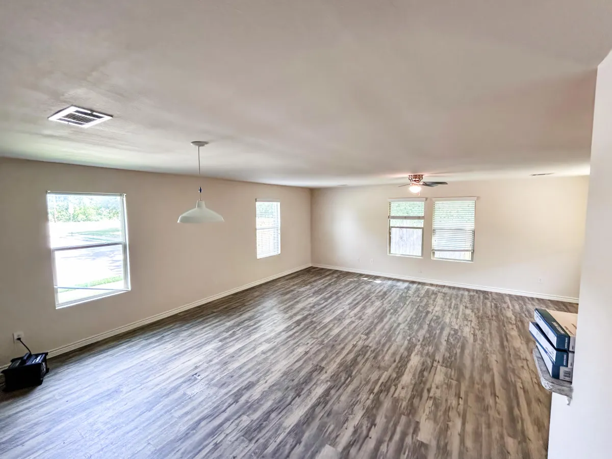 a living room filled with furniture and a kitchen