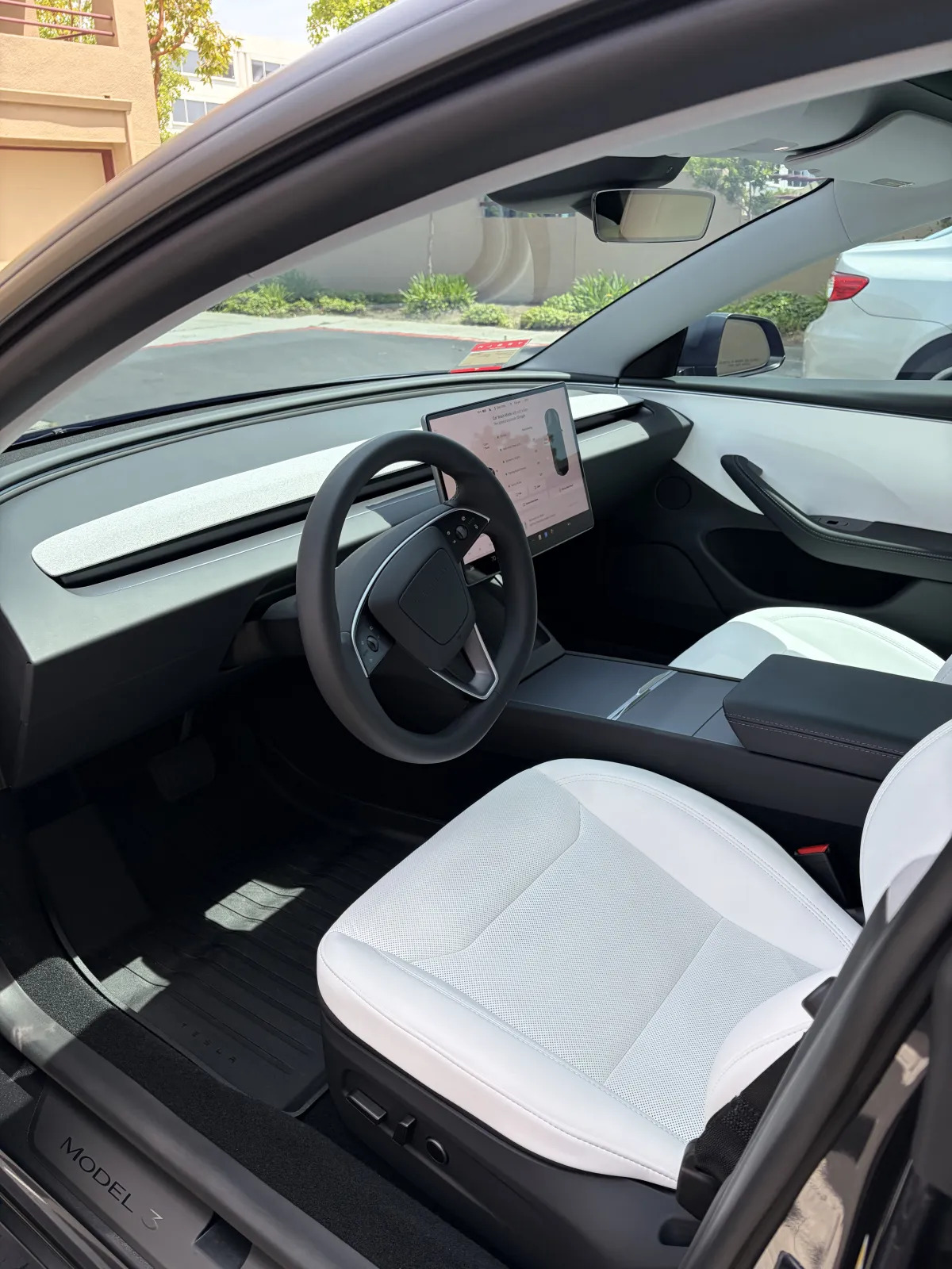 Coffee spill being blotted from a leather car seat with a microfiber towel