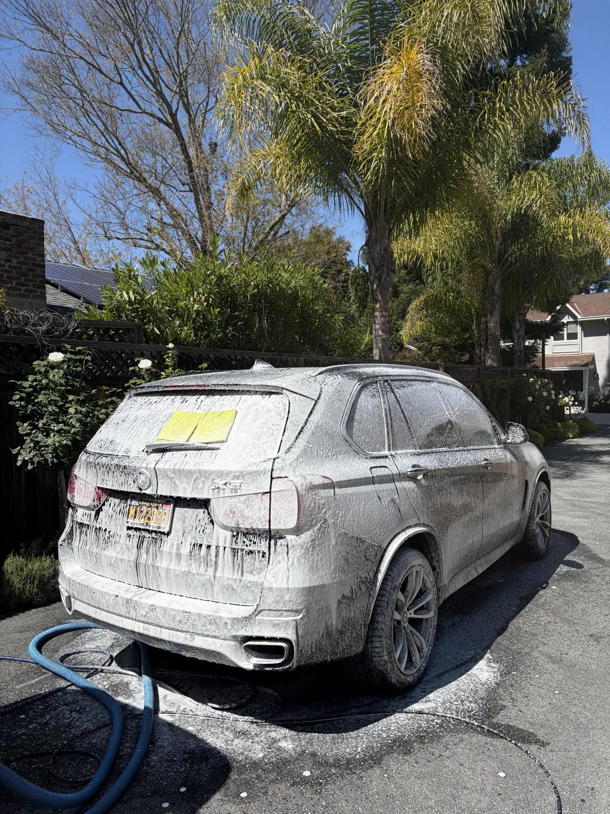 SUV rear covered in car wash soap suds during a professional detail in Menlo Park