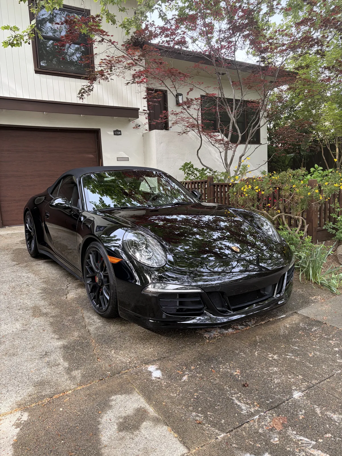 Shiny black car after professional paint correction, free of swirl marks