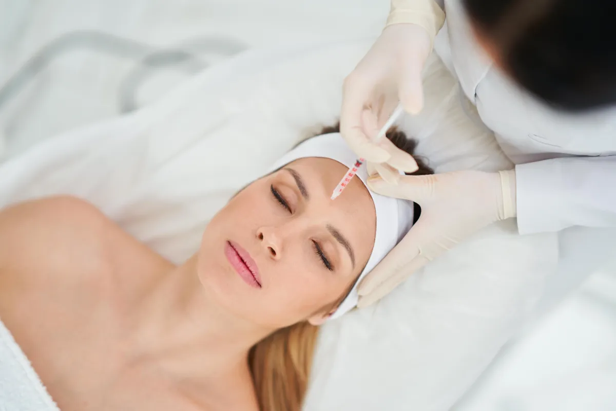 A Caucasian woman receiving a microdermabrasion facial treatment at Body in Balance, enhancing skin texture and glow with exfoliation.