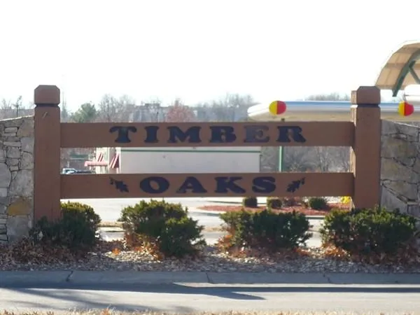 Wood pergola built over cedar deck in Timber Oaks backyard