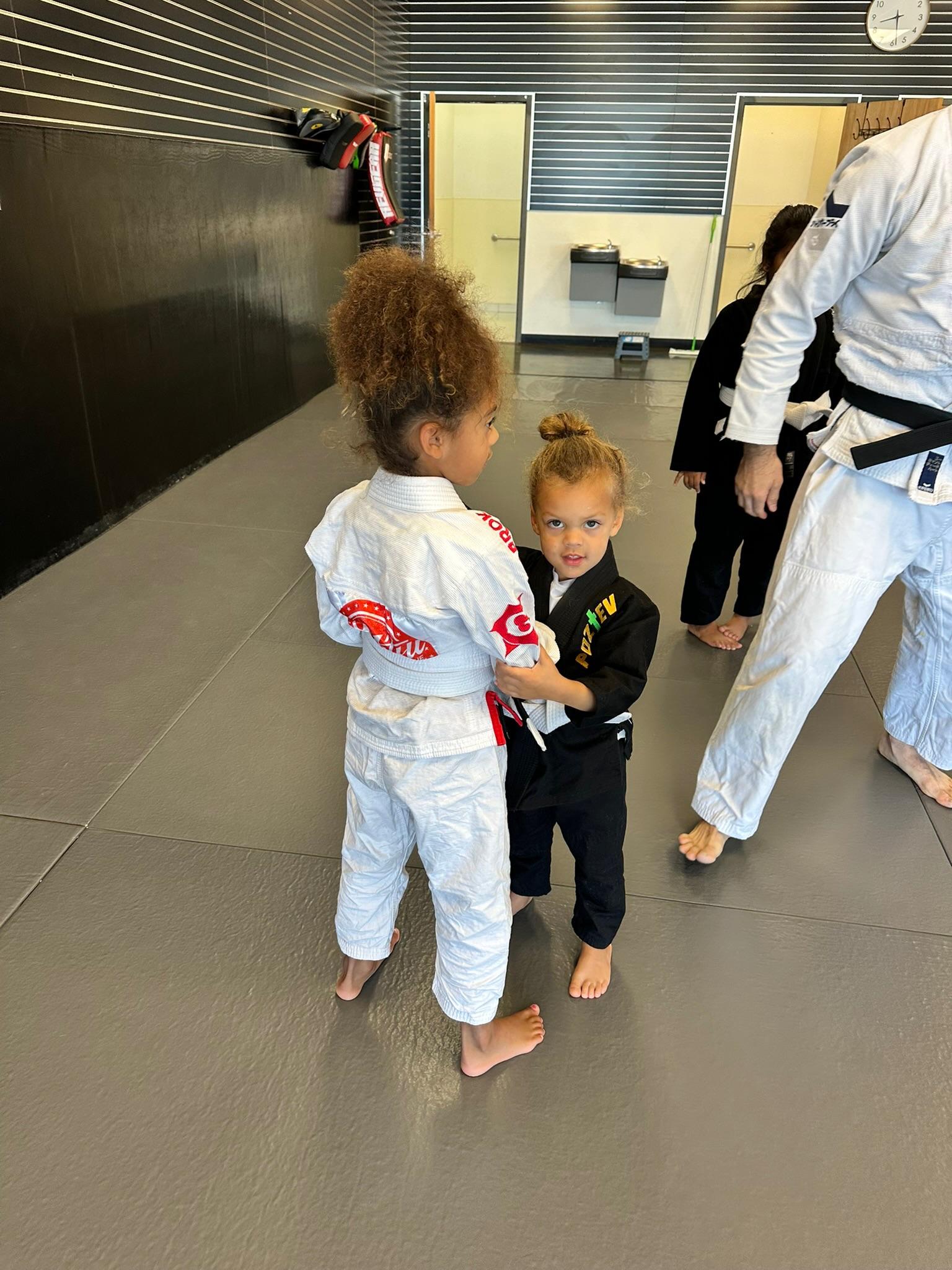 Group of kids in Gi smiling after Judo class