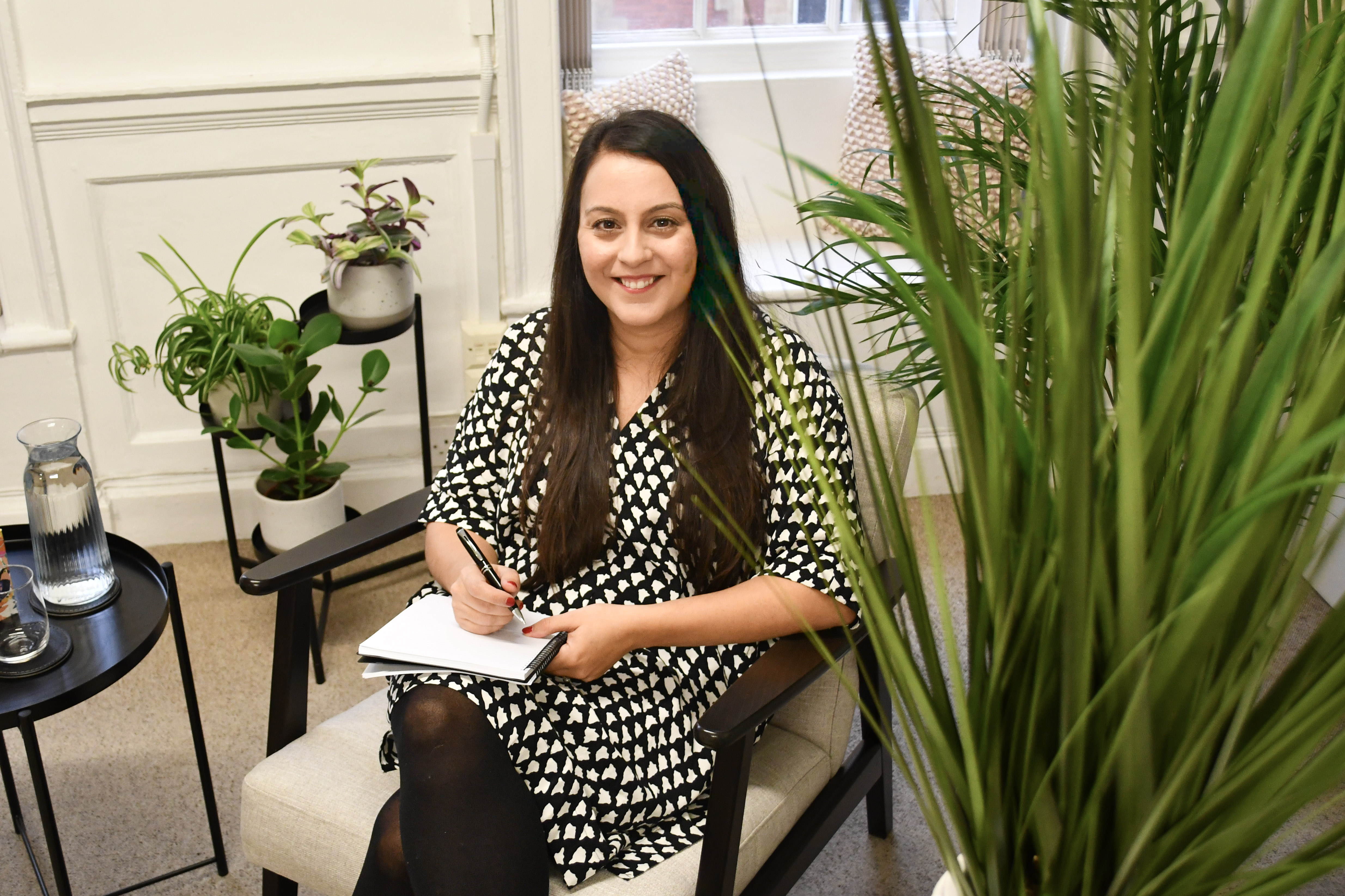 Dr Sara Schamborg, Practitioner Psychologist and trauma therapist, seated in her therapy room in Bristol