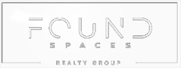 Found Spaces Realty Group logo. The word "Found" appears large in a modern font with "Spaces" centered below it. A thin rectangular box frames the text, broken at the bottom edge where "Realty Group" is displayed.
