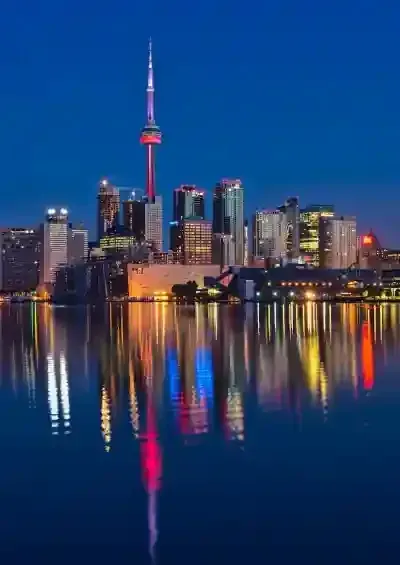 Night time scenic view of the Toronto skyline with reflection on the water