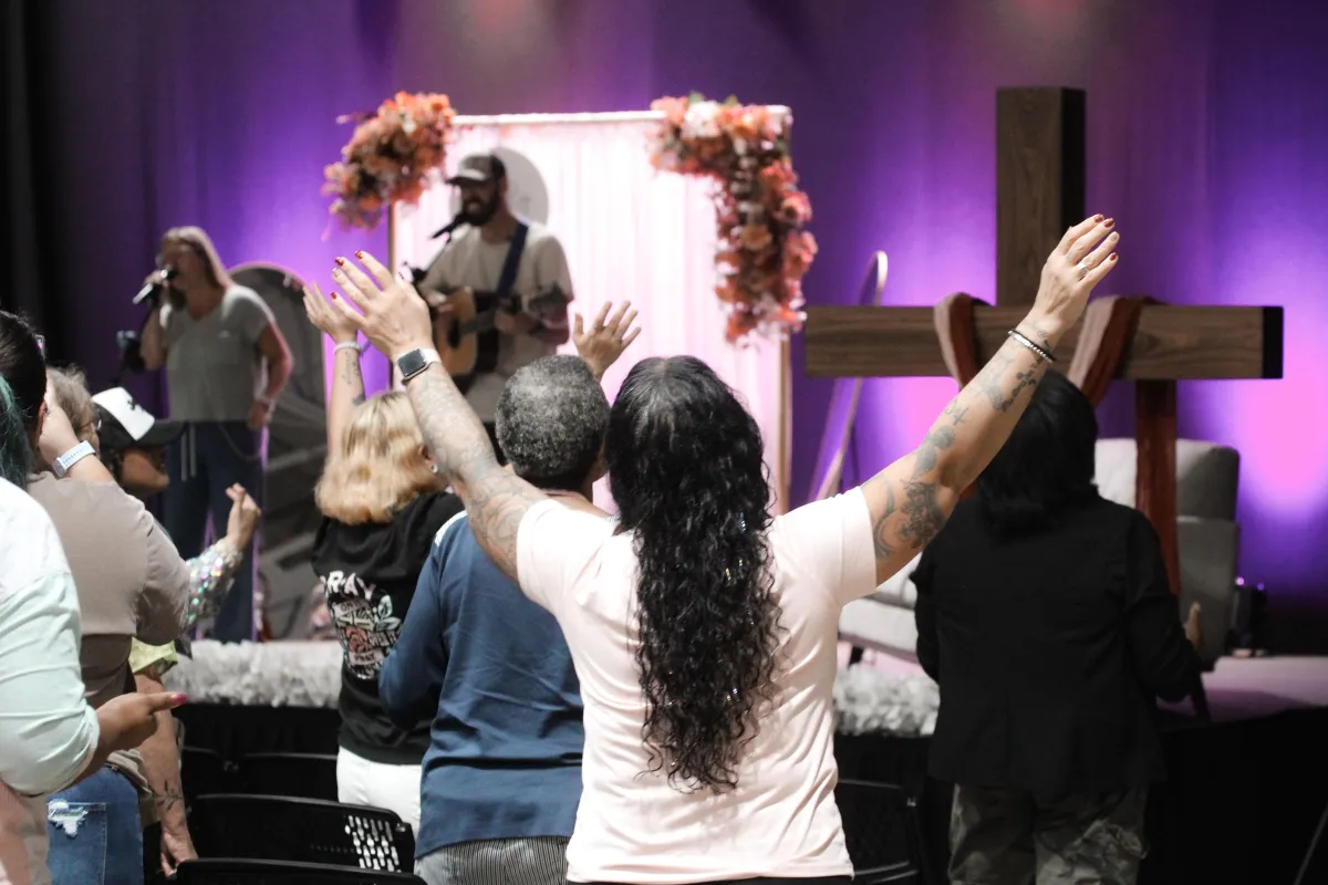a woman digging in the sand with a stick