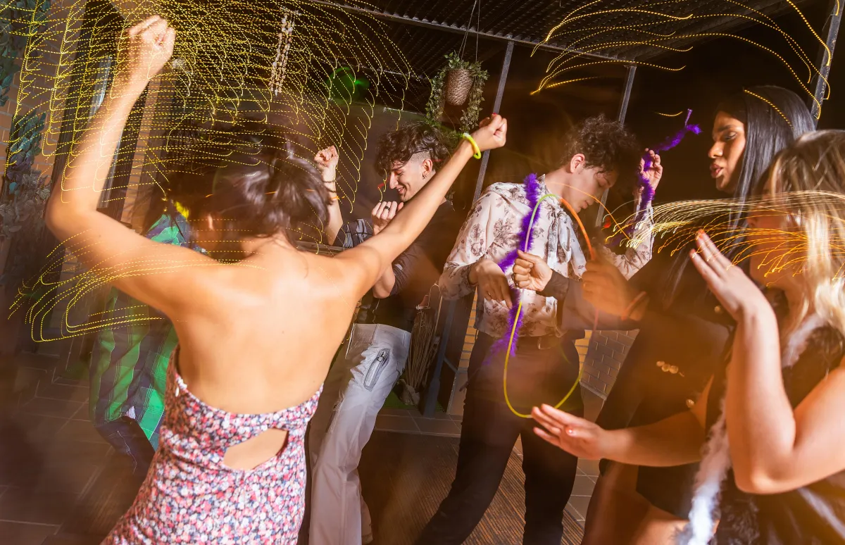 Guests dancing with neon glow sticks at a high-energy wedding party - DJ services in Austin by Dynamic Celebrations.