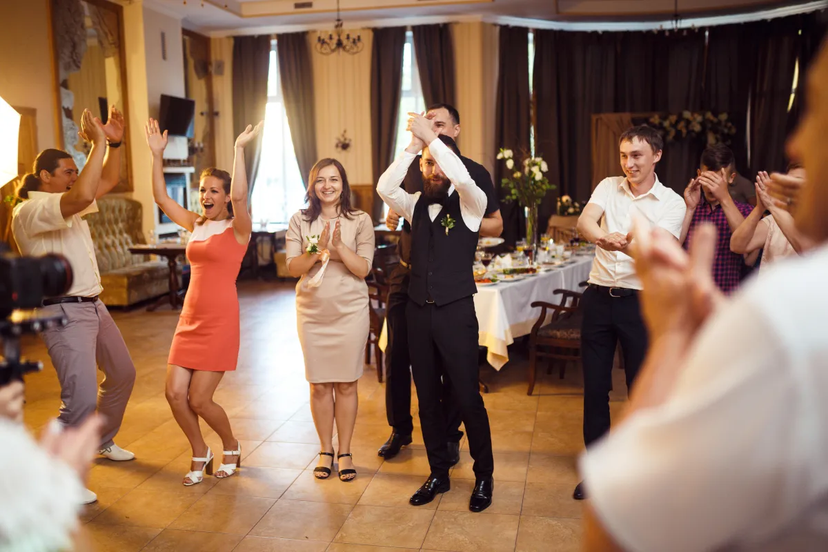 Wedding guests and groom celebrating on the dance floor with high-energy entertainment by Dynamic Celebrations.