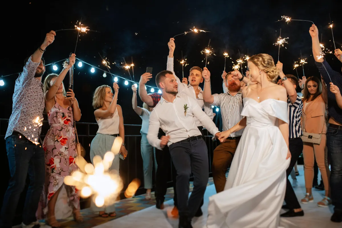 Bride and groom dancing under a sparkler send-off at a nighttime wedding - Luxury wedding DJs in San Antonio.