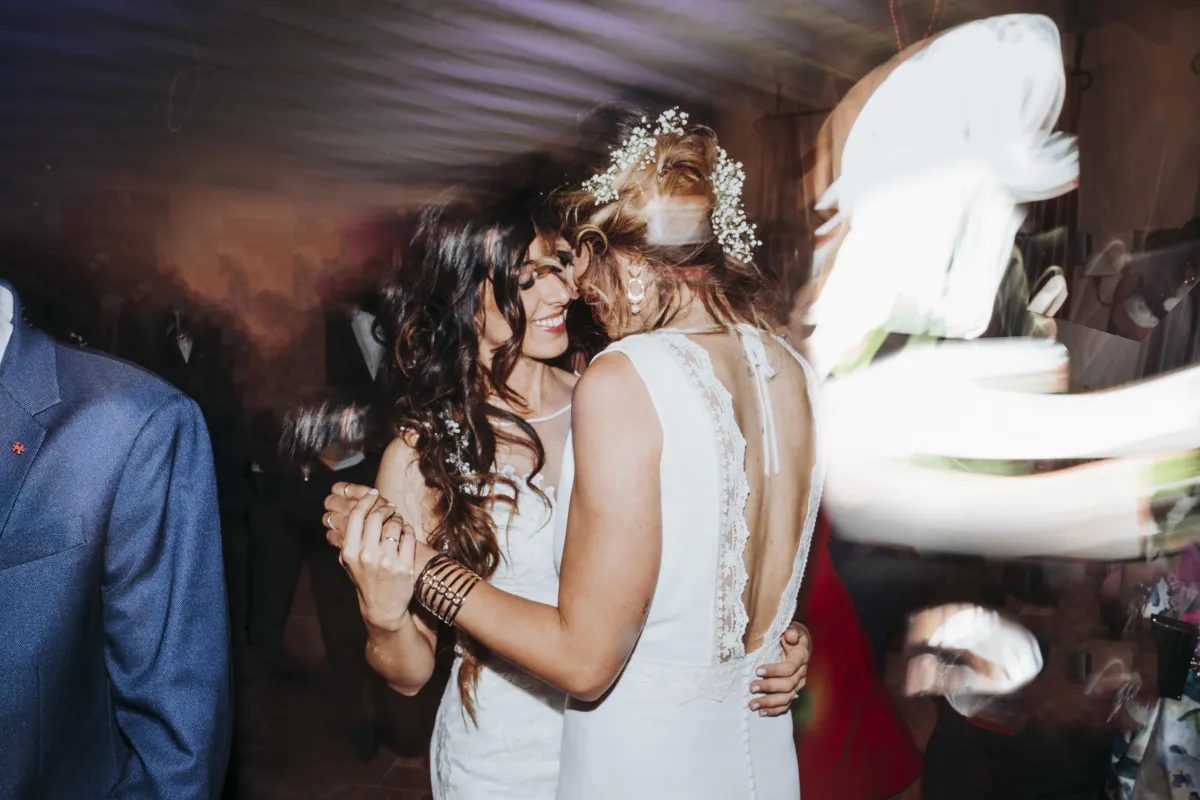 Two brides sharing a romantic first dance at their wedding reception in College Station, Texas. A beautiful LGBTQ+ wedding moment filled with love, joy, and celebration on the dance floor.