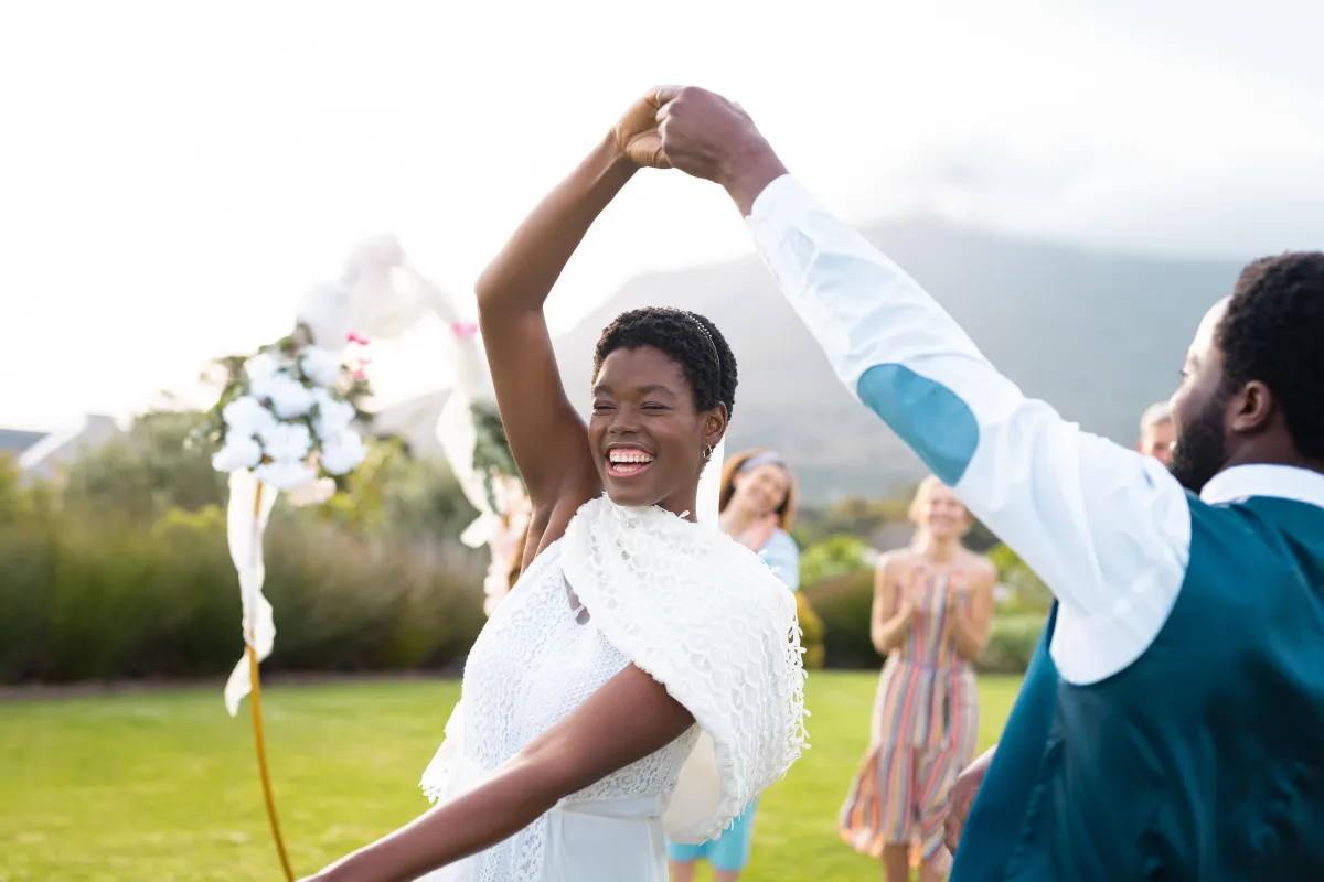 Outdoor wedding first dance with happy guests clapping in the background - Best Austin wedding DJs and entertainment.