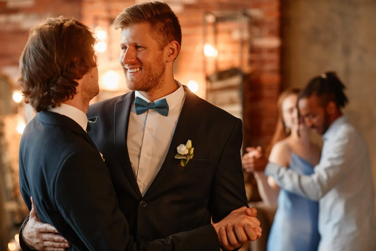 Same-sex couple sharing their first dance at an intimate wedding reception - LGBTQ-friendly DJs in Texas by Dynamic Celebrations."